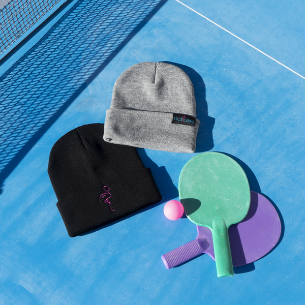black and grey beanies on ping pong table